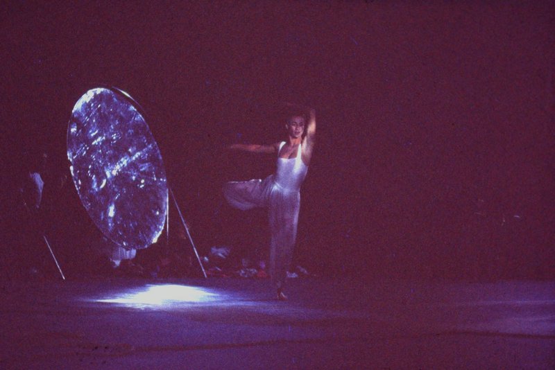 Cynthia Quinn of Momix dancing in front of the Archimedes reflector under moonlight